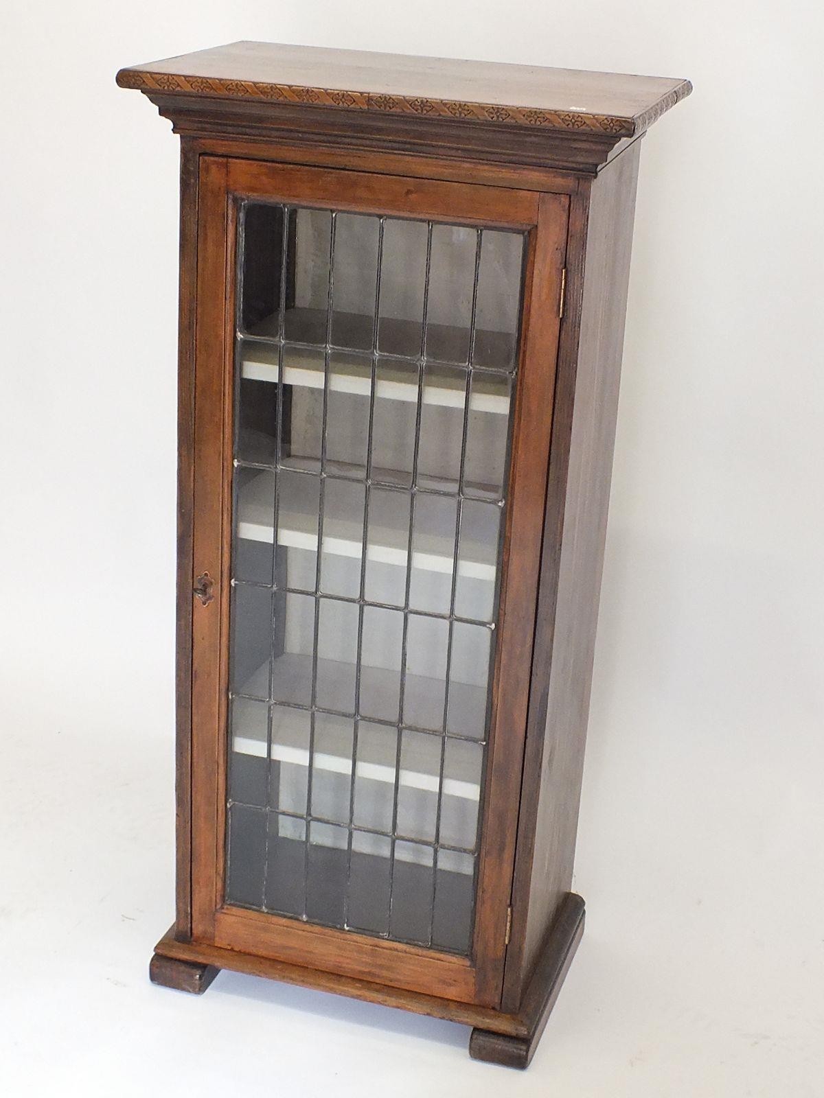 An oak style door lead glazed bookcase, 105 x 56 x 36cm