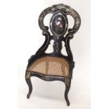 A Victorian Papier Mache chair with mother of pearl inlay and cane seat