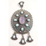 A large Eastern ethnic silver oval pendant set amethyst and turquoise, 11 x 6cm