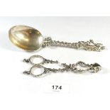 A continental silver serving spoon with apostle and a pair of ornate silver sugar nips a/f