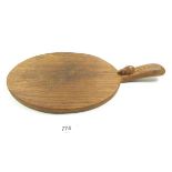 A Mouseman oval cheese board, 38 cm long including handle x 18cm wide