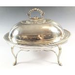 An oval silver plated entree dish and stand