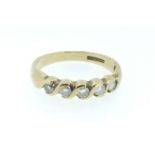 A 9 carat gold ring set five diamonds in scrollwork setting, size L