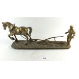 A brass group of miniatures and a horse and plough group