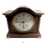 An oak arch top mantel clock