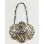 A Georgian silver Madeira label circa 1825 with flowers, vine and shell decoration(date letter