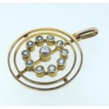 A 15 carat gold pendant with a central pearl and circle of small aquamarines 2.5g