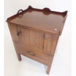 A Georgian mahogany commode or night table with gallery top over cupboard and commode drawer