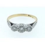 An early 20th century 18 carat gold and platinum set three stone diamond ring