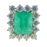 A fine quality 18 carat white gold ring set large Columbian emerald within fourteen stone diamond