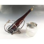 A silver plated bottle holder and a silver plated and cut glass biscuit barrel