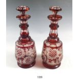 A pair of 19th century Bohemian red flashed decanters with cut decoration