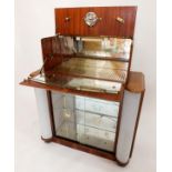 A 1950's walnut 'Havana' drinks cabinet with mirrored interior over pair of glazed and printed