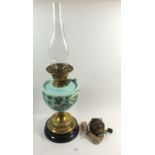 A Victorian oil lamp with painted reservoir and brass base, plus extra burner
