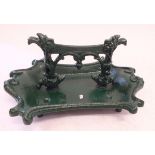 A cast iron boot scraper, later painted green