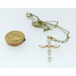 A 9 carat gold engraved circular locket 1.6g and a 9 carat gold crucifix on plated chain