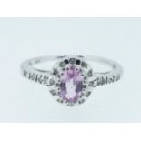 A 9 carat white gold cluster ring set pink stone and diamonds, size I to J