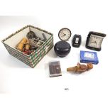 A box of miscellaneous collectables including corkscrews, bottle openers and alarm clocks