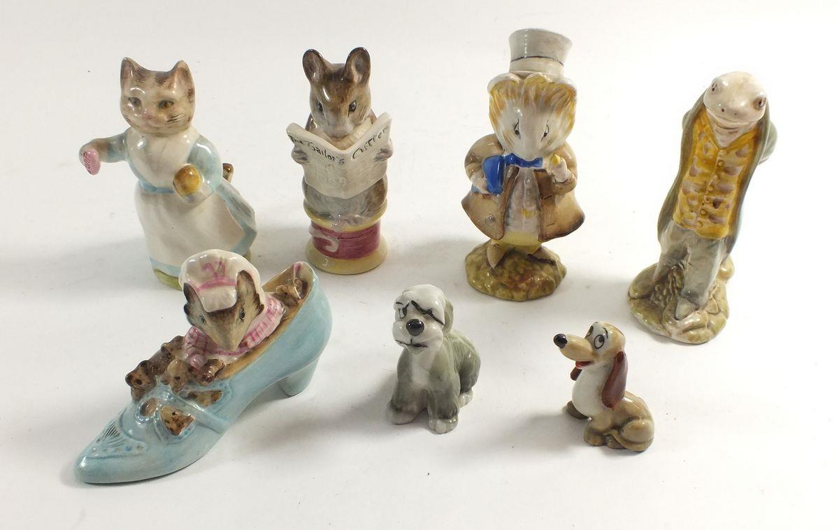 A Beswick figure 'The Amiable Guinea Pig' and 'Sir Issac Newton' plus three other Beatrix Potter