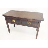 A Victorian stained oak side table with two deep drawers and inset brass handles, 108 x 47 x 70cm