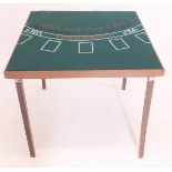 A folding card table with baize top