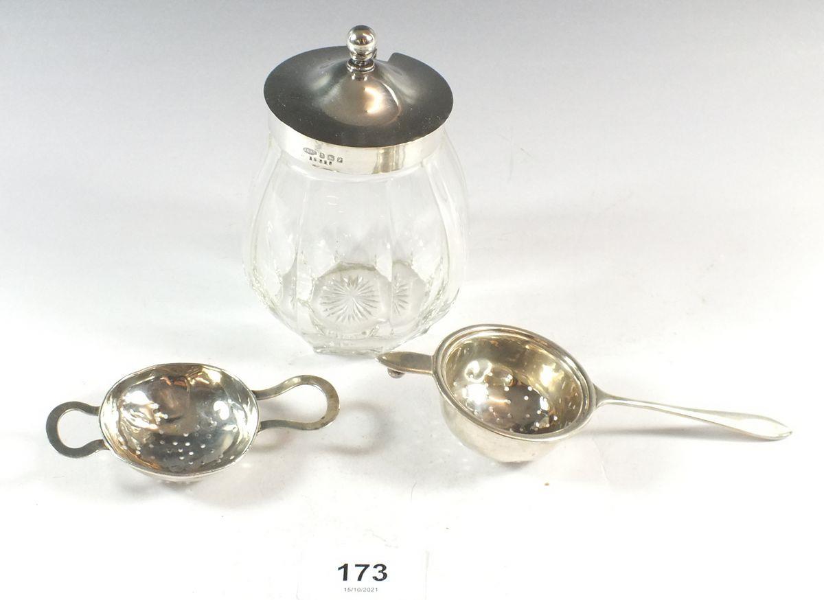 A silver topped glass preserve pot and two silver tea strainers, - tea strainers 44g