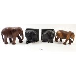A pair of carved wooden elephants and a pair of ebony elephant bookends