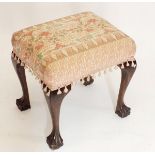 A dressing table stool on carved oak claw and ball supports