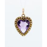 An Edwardian 9ct gold heart shaped pendant set central amethyst in seed pearl border, 14mm wide by