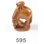 A Japanese carved boxwood horse netsuke