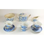 An early 19th century Willow pattern tea service comprising: teapot, jug, slop bowl, six cups and