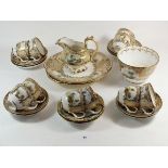 A Victorian tea service painted landscapes with gilt and cream reserves comprising: ten cups and