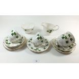 A Coclough Ivy tea service comprising: six cups and saucers, six tea plates, milk and sugar
