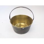 A brass preserving pan with iron handle