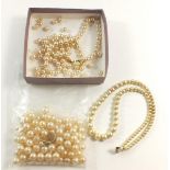A simulated pearl necklace with a 9 carat gold clasp together with a simulated pearl necklace (a/