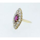 An 18 carat gold marquise form ring set ruby within diamond surround, size M, the face 2.2 x 0.9cm