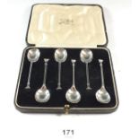A set of six silver seal top coffee spoons, cased, London 1938