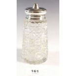 A cut glass sugar caster with silver lid