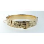 A 9 carat gold on metal core buckle form bangle with engraved decoration, total weight 24g