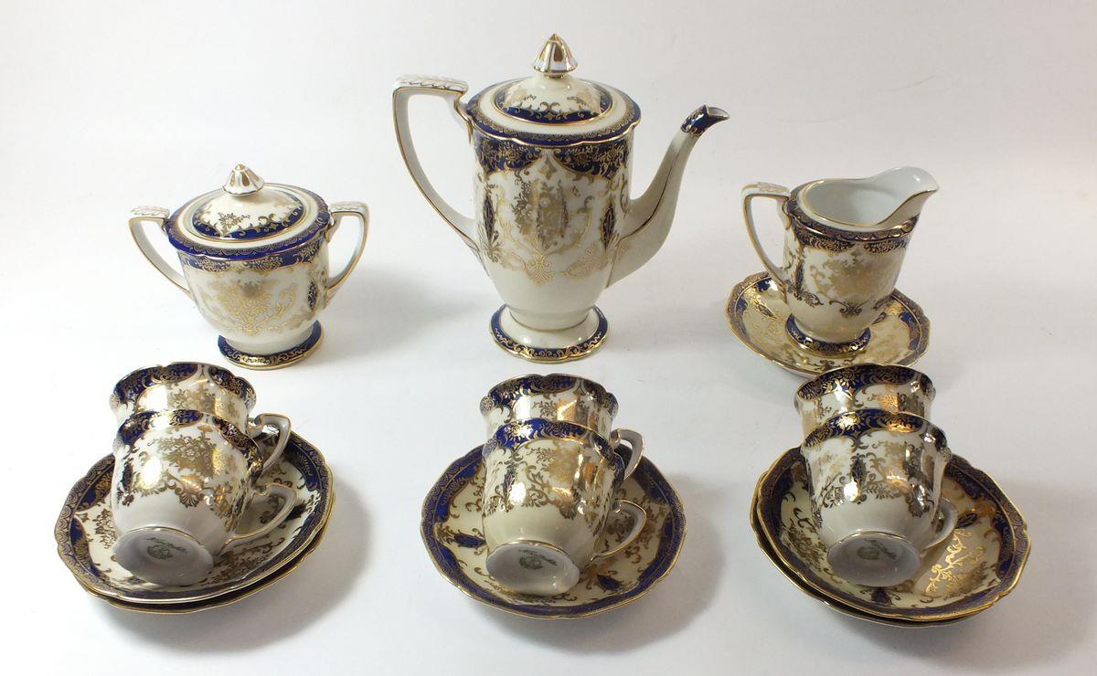 A Noritake coffee set in blue and gilt comprising: six cups and saucers, coffee pot, milk, and sugar