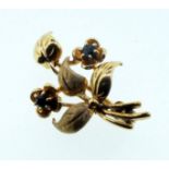 A 9 carat gold small sapphire set flower form brooch