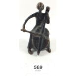 A small bronze of a cellist, 10cm tall