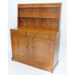 A Cotswold School light oak dresser with low back over two drawers (one fitted for cutlery) and