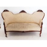 A Victorian triple arch back settee with scrollwork carved decoration, scroll over arms and supports