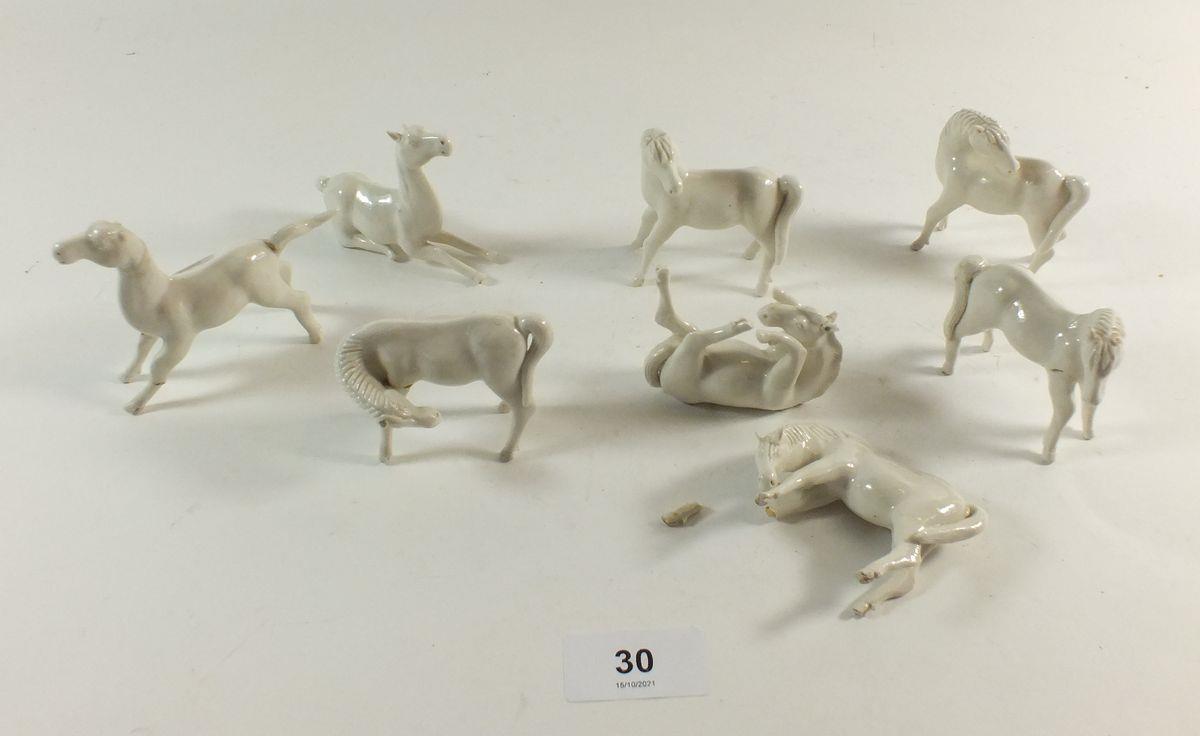 A set of eight Chinese white porcelain horses, and one a/f