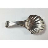 A Georgian silver bright cut engraved caddy spoon with scallop shaped bowl, London 1793, by