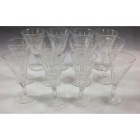 A set of seven faceted large wine glasses and five champagne flutes