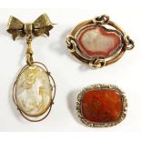 A 9 carat gold cameo brooch by W Bros on a gold plated bow form brooch, a Victorian yellow metal