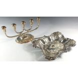 A silver plated cake basket and a silver plated candelabra