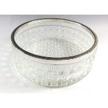 A cut glass fruit bowl with silver plated rim